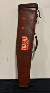 Vintage leather "leg of mutton" case designed for carrying a shotgun or rifle featuring a shaped design to fit the stock and barrel.