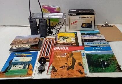 (2) GE Handheld CB Radios (Unable To Test / Needs Batteries.) StreetPilot 3 Portable GPS. (Unable To Test / Looks Complete.) Bycicle Cribbage Board (Looks Complete.) Travel Books + More.