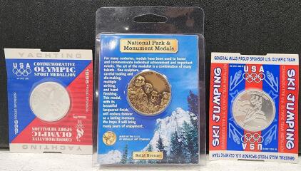 (1) Solid Bronze Medallic Art Company Mount Rushmore National Memorial Medal (1) 1996 Atlanta Olympics USA Yachting Commemorative Sport Medallion (1) General Mills Commemorative US Olympic Team Ski Jumping Medallion