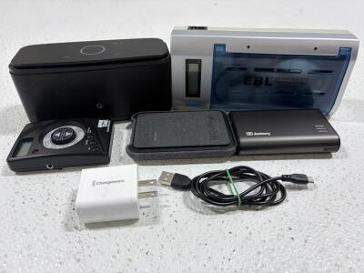 Assorted electronics, power banks, speaker, universal charger, charger block and cord.