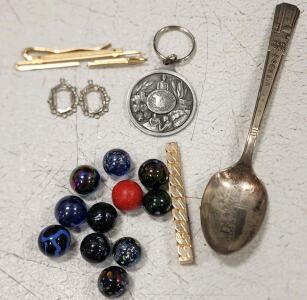 (1) 1939 New York World's Fair Souvenir Spoon (1) Vintage Promotional Keychain From "Rain and Hail Insurance Service." (2) Vintage-Style Filigree Silver-Plated Pendant Settings (2) Vintage Gold-Tone Tie Bar (11) Assorted Collectible Glass Marbles