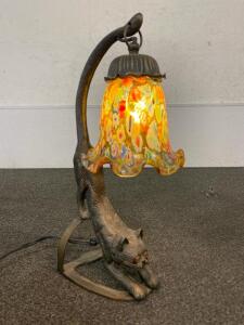 Art Deco Style Bronzed Metal Table Lamp Featuring A Stretching Cat With Amber Eyes And A Suspended Millefiori Glass Shade