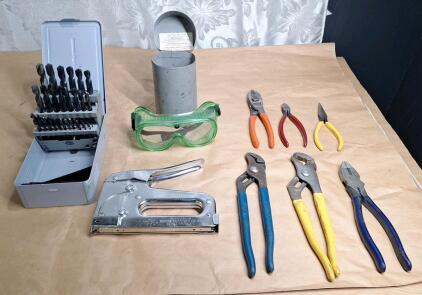 (1) 29-Piece Drill Bit Set, (1) Arrow T25m Staple Gun, (2) Pair Of Slip Joint Pliers, (1) Pair Of Linesman Pliers, (1) Pair Of Cable Cutters, (1) Pair Of Wire Cutters, (1) Pair Of Needle Nose Pliers & (1) Pair Of Safety Goggles W/ Metal Storage Case