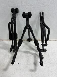 2 FretRest FS100B Black Guitar Stands &ndash; Foldable Steel Tripod with Foam Padding for Acoustic & Electric, one with no visible brand.