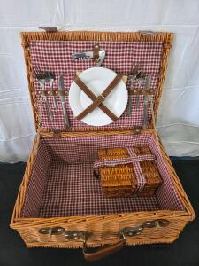 Vintage wicker picnic basket set with dishes, bottle opener and glasses. Please see photos and inspect in person.