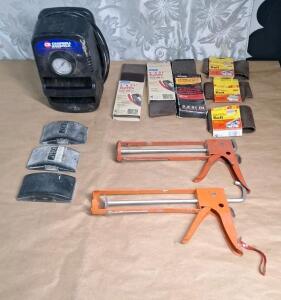 (1) Campbell Hausfield Electric Tire Inflator, (2) Caulking Guns, (3) Rubber Sanding Blocks & (8) 3" x 21" Belt Sander Belts