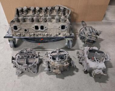 Lot Of Assorted Used Automotive Parts, (3) Carburetors, (1) Pair Of Heads, (1) Distributor & (1) Wheel Dolly