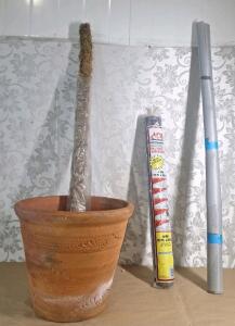 (1) XL Terra Cotta Planter, (1) 48" Moss Pole, (1) 10 x 25 Foot Roll Of Black Plastic Sheeting & (1) 54"W Roll Of Black Foux Leather
