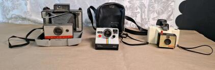 (1) Vintage Polaroid Automatic 104 Folding Land Camera, (1) Vintage Polaroid BC Series Land Camera w/ Case & (1) Vintage Polaroid Swinger Model 20 Land Camera