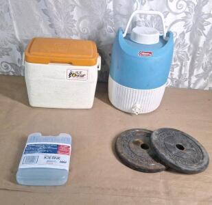 (1) Coleman Lil Oscar Cooler, (1) Coleman 3-Gallon Drinks Cooler/ Dispenser, (1) Reusable Blue Ice Pack & (2) 10Lb Iron Weights