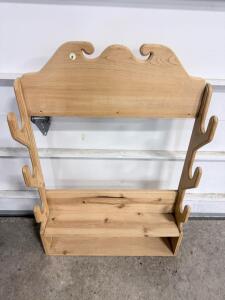 Wall-Mounted Wooden Rifle Rack with Decorative Top Edge and Lower Shelf