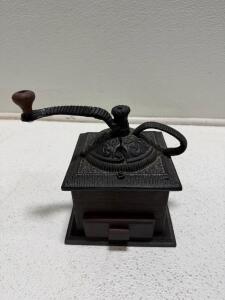 Antique-Style Manual Coffee Grinder with Ornate Cast Iron Top and Wooden Base