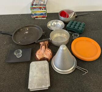 Mixed Kitchenware Lot with Fry Pan, Colander, Plates, Copper Mold, and 15 DVDs