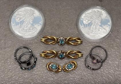 (2) 2024 American Eagle One Ounce Silver Proof Coin (unable to Verify) (1) Women's Black Metal Wedding Set w/ Green and Blue Stones (1) Women's Black Metal Wedding Set w/ Pink and Purple Stones (2) Gold Tone Pins with Blue Stones & 2 small Spare Pieces