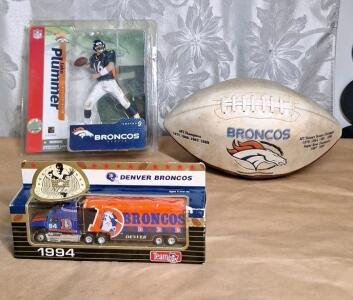 Lot Of Denver Broncos Collectibles, (1) Denver Broncos Commemorative Football, (1) Jake Plumber Figurene Sealed In Original Packaging & (1) Matchbox Die Cast 1994 Denver Broncos Commemorative Semi Truck Sealed In Original Packaging
