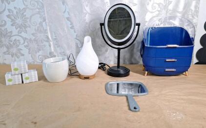 (1) Lighted Makeup Mirror, (1) Hand Mirror, (1) Makeup Caddy, (1) Essential Oils Difuser & (1) Yankee Candle W/ (3) Spare Bulbs