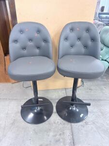 Pair of Gray Faux Leather Tufted Bar Stools with Metal Pedestal Base and Footrest