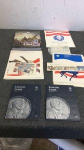 (3) Mint Sets Of Commemorative Stamps (1) An American History Album Stamp Book (2) LincolnCents Collection Albums