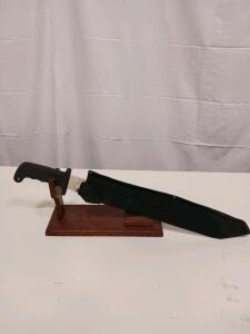 Sawback Machete with Black Handle, Sheath, and Display Stand