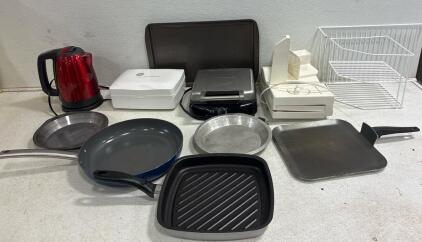 FARBERWARE waffle maker ( tested). RIVAL fold up Slicer, includes accessories ( tested) unbranded electric kettle( tested). GENERAL ELECTRIC hand mixer, Miscellaneous pans, baking tray and wire racks for storage.