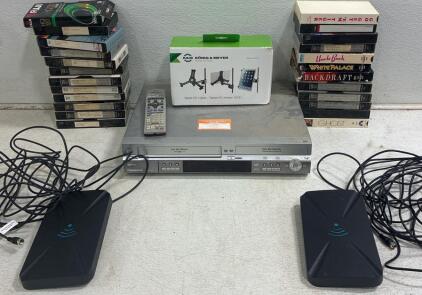 PANASONIC DMR- ES30V Multifunction DVD/VHS Recorder combo unit(unable to test). (30) vintage VHS tapes Including UNCLE BUCK, BackDraft and GHOST. (2)digital indoor TV antenna, KONIG&MEYER Tablet PC Holder.