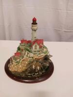 Collectible Lighthouse Figurine with Detailed Coastal Scene on Wooden Base