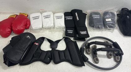 (5)Champions corner knee guard black. (6) Champion corner knee guard white, (2)EVERLAST boxing gloves (size 14) , ATA Rib Protector, (2)ATA sparring Foot pads, Golds Gym Brand Push-up Stands,Body Sport Pilates ring