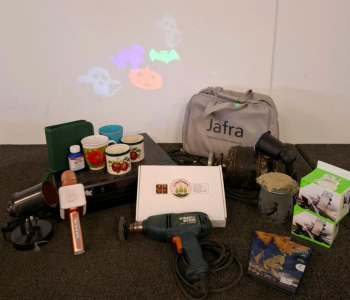 Black And Decker Electric Grinder (Powered On), 5 Disk DVD Player (Powered On), Halloween Rotating Projector Light, Jafra Cosmetics International Organizer Bag, And More