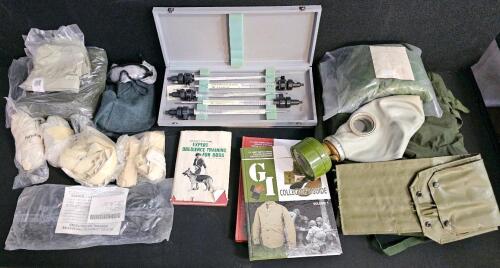 (#3) Mixed Military Collectible Lot: Eight Military Thermometers in Matching Cases, Woodland Camo Poncho Cover, Bivy Covers, Gas Mask and Chemical Gloves, GI Collectors Guide Vol 1 & 2, and More!