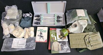 (#3) Mixed Military Collectible Lot: Eight Military Thermometers in Matching Cases, Woodland Camo Poncho Cover, Bivy Covers, Gas Mask and Chemical Gloves, GI Collectors Guide Vol 1 & 2, and More!
