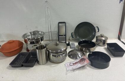 Chafing dish, mandoline with accessories, various pots and pans.meat loaf dishes, Dolly Parton measuring cups, Scheurich Keramik terracotta baking pot.