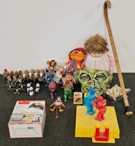 Rock 'Em Sock 'Em Robots, Creme Brulee Set, Small Wooden Music Box, Vintage Pull String Wooden Doll, Vintage He-Man And Skeletor Action Figures, Baby Doll, Ernie, Wooden Cane, Alien Mask, Vintage Monkey Doll, Assortment Of Small Dolls And Animals, Chess P