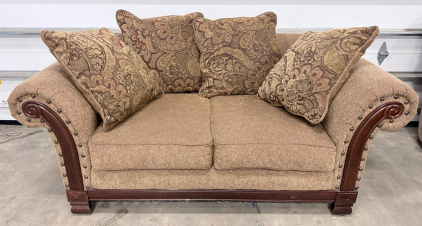 Tan Rolled Arm Loveseat With Nailhead Trim, Carved Wood Accents, And 4 Paisley Accent Pillows