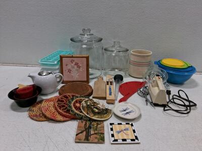 Assorted Kitchenware Lot: GE Hand Mixer, Glass Canisters, Tupperware Bowls, Coasters, 24 Items