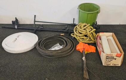 Mixed Outdoor/Hardware Lot: Yakima Black Roof Rack Crossbars, Weighted Standing Umbrella Base, Metal Weed Puller, Ortho Hose w/ Hardware, Set of Orange Lawn Flags, Assorted plastic sheets, Two Ropes, Green Plastic Bucket