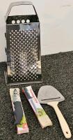 (XB) Mixed Collectible and Kitchen Lot: Legend of Zelda Shield Backpack, 3 Assorted Tupperwares, Plastic Pitcher, 3 Assorted Travel Coffee Mugs, Olaf Snowcone Maker, Popsicle Mold, Cheese Grater and Cheese Knife, Two Paring Knives, Baby Gate, 8 Sets of Co - 8