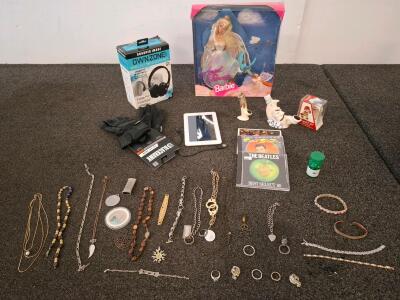 Vintage barbie in packaging, costume jewelry, hp tablet woth charge cord and more