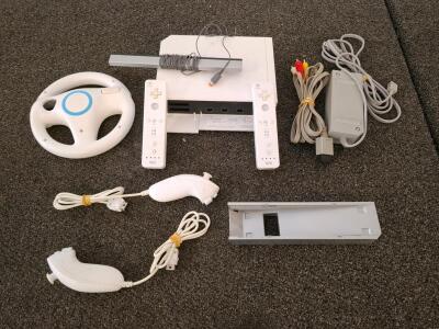 Nintendo Wii Console RVL-001, 2 Remotes, 2 Nunchuks, Sensor Bar, Cables, Steering Wheel, Stand(powered on. ( Shelf A