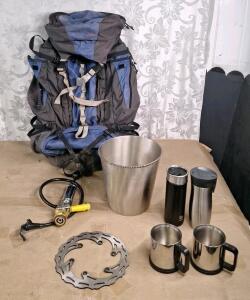 (1) 65L Backpack, (1) Insulated Water Bottles, (2) Stainless Steel Coffee Mugs, (1) Micro Matic Beer Keg Pump, (1) Metal Wastebasket & (1) 8-1/2" Motorcycle Brake Rotor