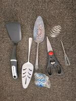 Monitor( powered on),and three keyboards. 7-Piece Stainless Steel Kitchen Utensil Set: 3 Whisks & 4 Measuring Spoons, Picture Frames, And More - 3