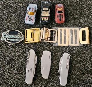 Lot of Pocket Multi-Tools, Die-Cast Cars (RX7, MR2), and Belt Buckles Including "Grandpa" Design