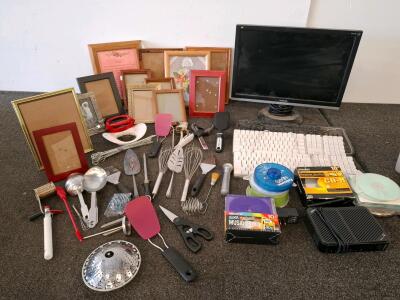 Monitor( powered on),and three keyboards. 7-Piece Stainless Steel Kitchen Utensil Set: 3 Whisks & 4 Measuring Spoons, Picture Frames, And More
