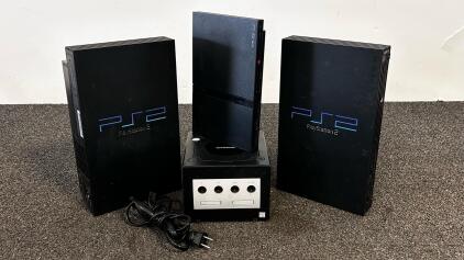 3 Sony PlayStation Consoles (2 Tested And Power On), Nintendo GameCube And 1 Power Cable