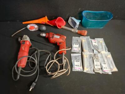 Milwaukee 6130-33 4-1/2" Angle Grinder, 7.0A, 11,000 RPM, 120V and Milwaukee drill corded. Both powered on. Miscellaneous funnels, cabinet handles.