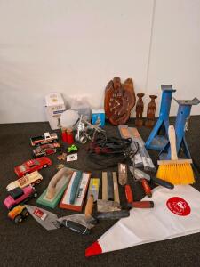 Large mixed lot. Heavy duty jacks, jumper cables, floats and dry wall tools. Vintage wood clock and wood sculptures. Desk lamps, unable to test. collectible model cars and more