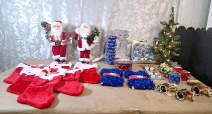 (2) 16" Santa Claus Figures, (6) Stockings, (1) 24" Mini Lighted Christmas Tree & Assorted Ornaments & Decor