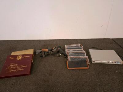 Pistol belt, with speed loader and ammo, Koss KD155 Slim DVD/CD/MP3 Player with Progressive Scan and MP3 Playback powered on. vintage record set. Leather wallet/ organizers