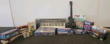 Casio keyboard, toy guitar, severL board games and VHS Movie Lot &ndash; Jurassic Park, Rudolph, Dragonheart, Animal Bites, 20+ Titles, Family & Kids