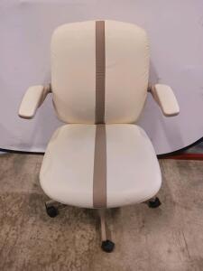 Cream Vinyl Office Chair with Fixed Armrests, Medium Back, Dual-Wheel Casters, Taupe Accent