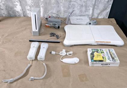 (1) Wii Console W/ Stand, (2) Remote Controllers, (1) Nunchuk Controller, Sensor Bar, AC Adapter & AV Cable, (1) Balance Board & (3) Games